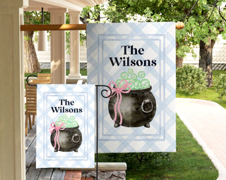 Personalized Halloween garden flag with bubbling green cauldron and pink bow – custom family name outdoor décor