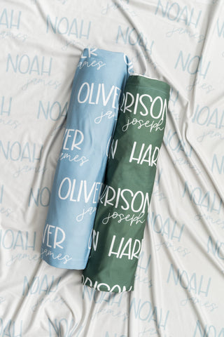 Soft neutral swaddle and personalized birth stat sign for newborn photography props.