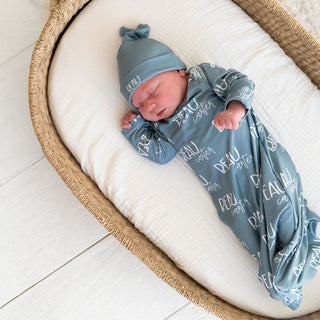 Personalized newborn swaddle blanket in soft blue with matching knotted hat