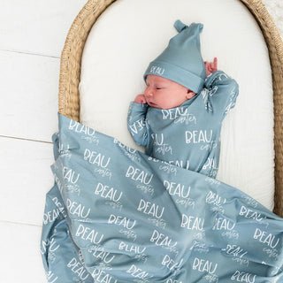 Stretchy personalized newborn swaddle with matching beanie hat