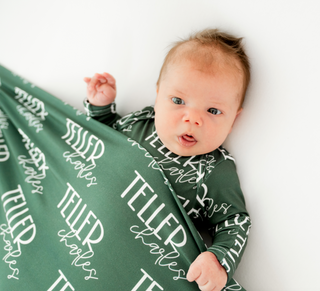 Custom baby name swaddle and announcement disc set, perfect for gender reveal and baby shower gifts.