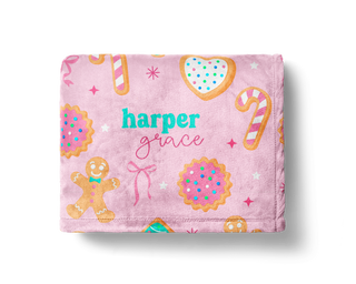 Pink Christmas blanket with gingerbread cookies, candy canes, and custom name design.