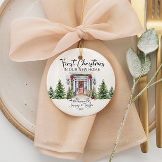 Custom first Christmas at new address ornament with house illustration, evergreen trees, and personalized text.