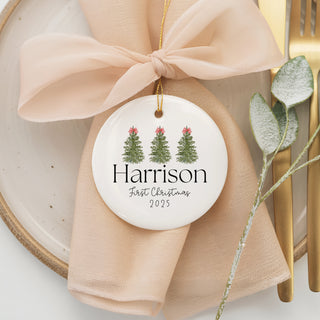 Custom ceramic ornament featuring three decorated Christmas trees with bows, personalized with name “Harrison” and year 2025 — baby’s first Christmas keepsake.