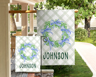 Personalized green wreath garden flag with blue bows and family name "Johnson"