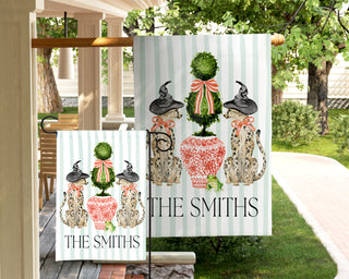 Custom Halloween garden flag with watercolor dogs in witch hats, a decorative topiary, frog, and personalized family name for fall porch decor.
