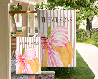 Personalized garden flag featuring a watercolor boxwood topiary with a peach ribbon bow and custom family name.