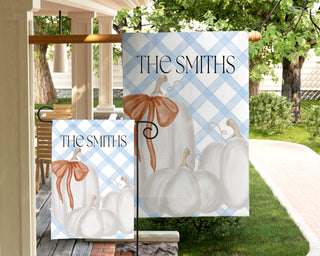 Personalized garden flag featuring a watercolor boxwood topiary with a peach ribbon bow and custom family name.