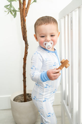 Infant wearing striped fish bamboo pajamas – soft eco-friendly fabric