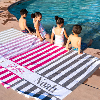 Custom name pool towels for children – vibrant stripes ideal for beach trips, pool days, and summer vacations.