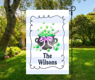 Striped Halloween garden flag featuring bubbling witch cauldron with bow – personalized porch and lawn decoration