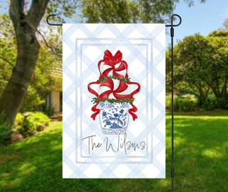 Personalized Christmas garden flag featuring red ribbon topiary in blue chinoiserie planter – The Navy Knot holiday décor