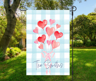 Easter porch decor featuring personalized garden flag and door pennant, blue patterned bunny artwork on gingham, custom family welcome sign