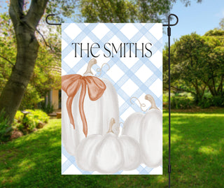 Personalized topiary garden flag featuring a boxwood topiary with a peach bow in a chinoiserie planter and a custom family name on a blush striped background.