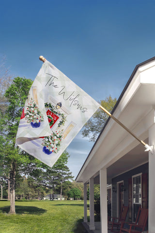 Personalized holiday yard flag with red door and festive greenery – custom family name Christmas décor