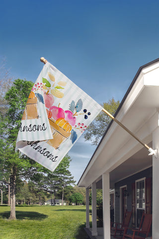 Custom autumn garden flag with watercolor apples, pumpkins, and berries in a wooden crate, personalized with your family name for farmhouse porch decor.