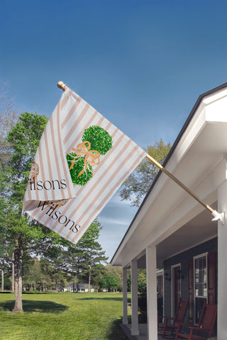 Custom garden flag with a boxwood topiary, decorative chinoiserie planter, and personalized family name for elegant porch decor.