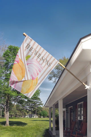 Custom garden flag with a boxwood topiary, decorative chinoiserie planter, and personalized family name for elegant porch decor.