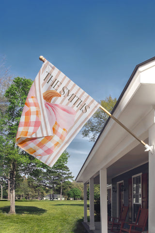 Personalized garden flag featuring a watercolor boxwood topiary with a peach ribbon bow and custom family name.
